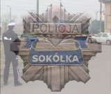 Odznak policyjna - Sokółka. Przejazd kolejowy w tle.