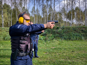 Policjant z bronią na strzelnicy.