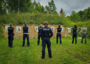 Policjanci z bronią na treningu strzeleckim.